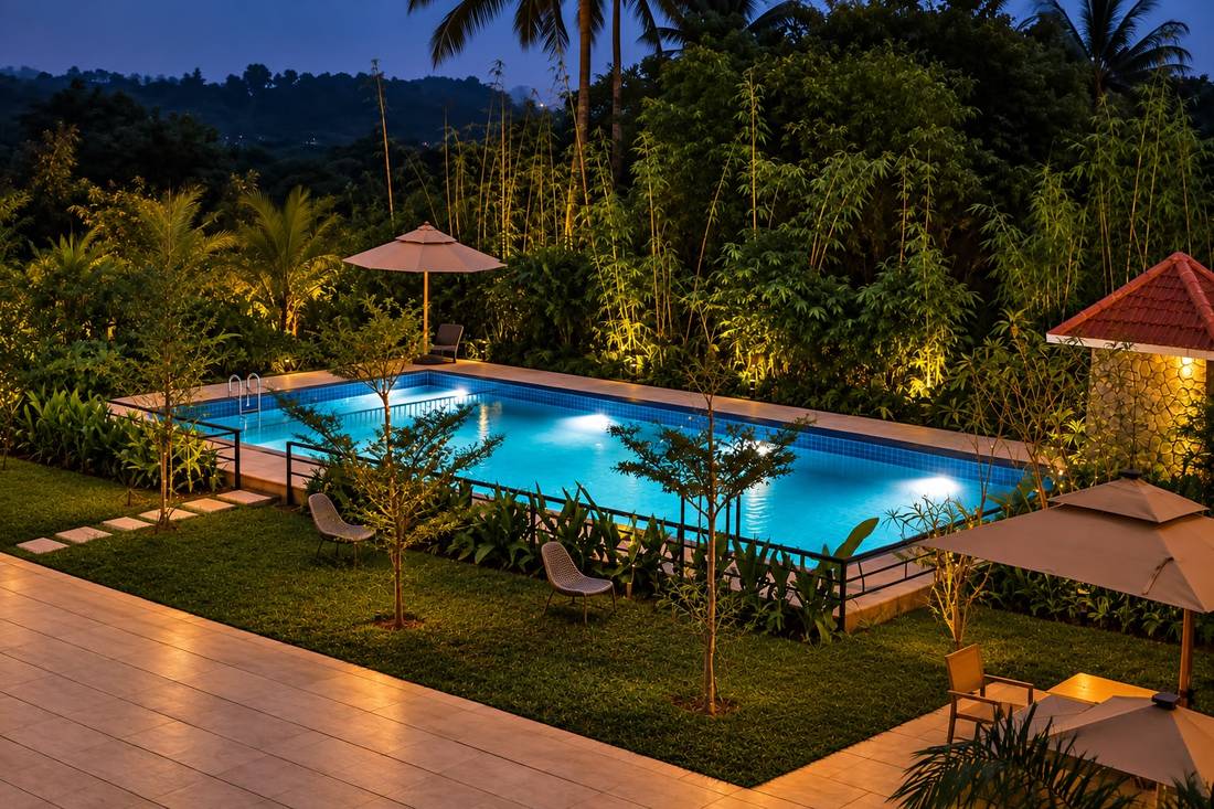 Pool and garden at Nilara Hills nature resort in Mananthavady, Wayanad, at dusk