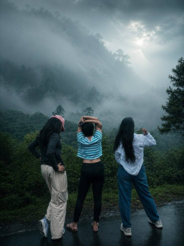 Friends looking out over misty Wayanad hills