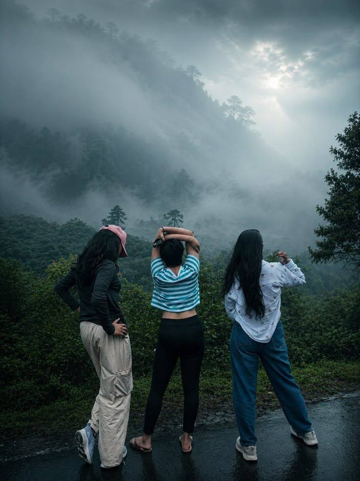 Travellers looking out over misty hills on a rainy mountain road